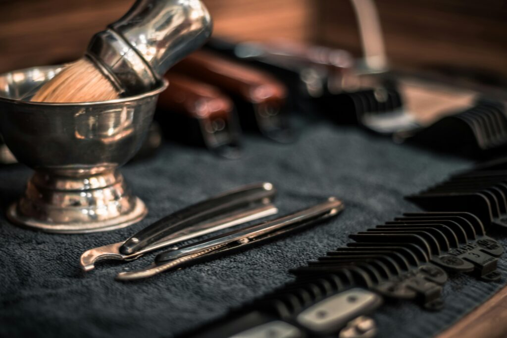 pexels-photo-1319459-1319459 Close-up of neatly arranged barber tools, including razors and combs, highlighting precision.