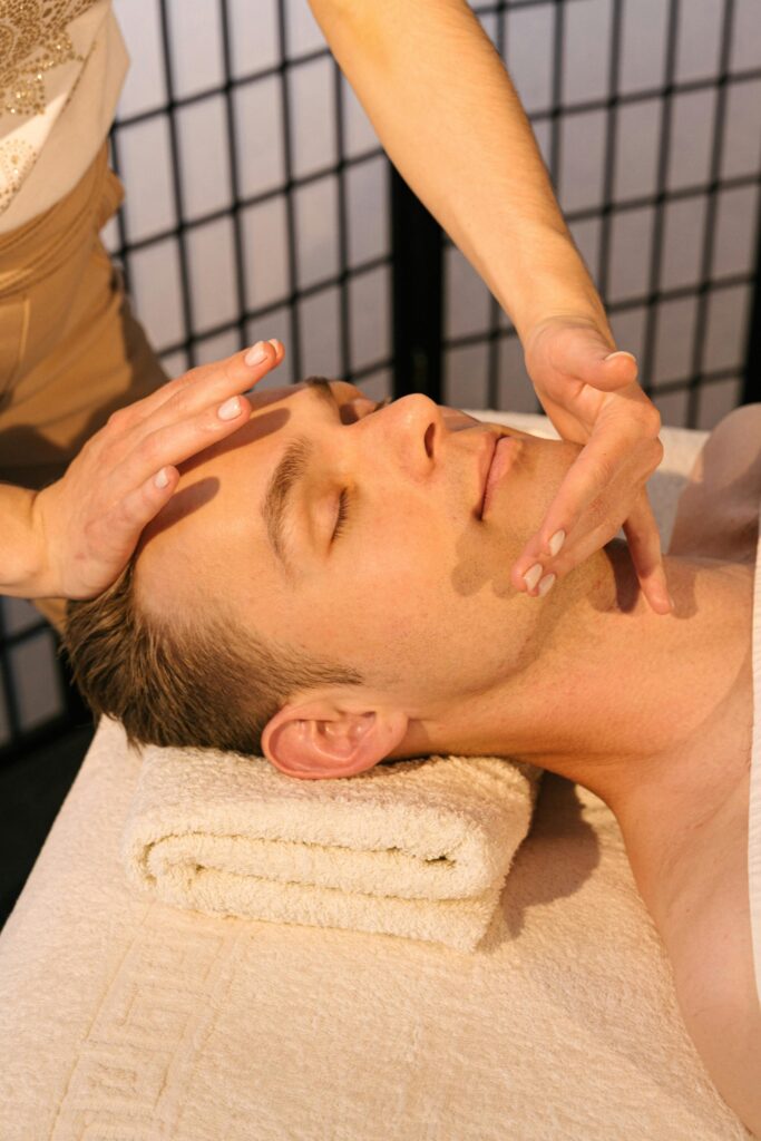 pexels-photo-4599431-4599431 Man receiving a calming face massage at a professional spa, emphasizing relaxation and wellness.