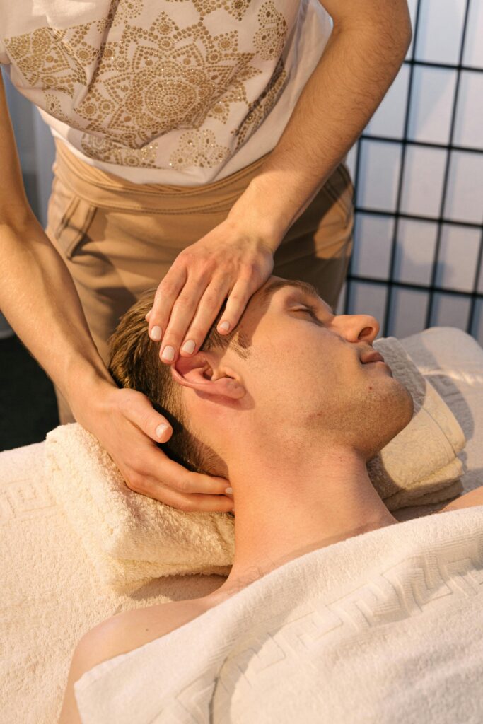 pexels-photo-4599434-4599434 Close-up of a man receiving a relaxing head massage in a tranquil spa environment.